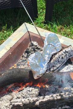 an outdoor grill with hot coals and marshmallows