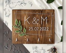 a wooden sign that says k & m and is next to some keys