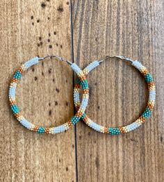 A pair of hoop earrings made with seed beads in the desert colors of beige, tan and unique Picasso turquoise beads. Comes in one of 5 sizes! 30mm (1 inch) 40mm (1.5 inch) 50mm (2 inch) 60mm (2.5 inch) 70mm (3 inch) These one of a kind earrings are fantastic for raves, night clubs, parties, summer vacations, festivals or just for a pop of color in your wardrobe.  Made with a spring clasp for ease. Hypoallergenic professional grade metals, none of the cheap stuff used here! Want another size or ha Flag Beads, Cheap Stuff, Boho Hoop Earrings, Desert Colors, Night Clubs, Desert Dream, Summer Vacations, Beading Ideas, Bead Work Jewelry