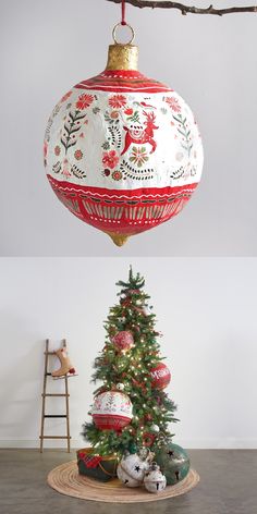 an ornament hanging from a tree with ornaments on it and a teddy bear underneath