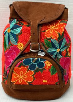 1 of a kind backpack Hand made by artisan's in Guatemala Each backpack has its unique embroidery pattern due to the handmade nature.   * Front Zipper pocket  * Adjustable straps  * Belt buckle closure  * Floral Embroidery  Perfect for traveling, hiking, or for a gift for someone special!  Approximate Measurements  L x W x D 11 in. x 12 in. x 5 in. Handmade Outdoor Backpack, Handmade Brown Travel Backpack, Floral Embroidered Backpack For Daily Use, Floral Embroidery Backpack For Everyday Use, Handmade Travel Backpack, Floral Embroidery Travel Backpack, Handmade Outdoor Standard Backpack, Everyday Floral Embroidery Backpack, Casual Floral Embroidered Backpack