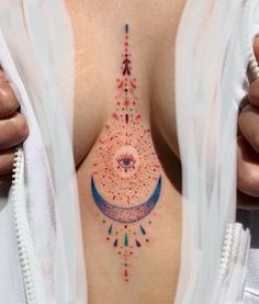 a woman's chest with an arrow and stars on it, in the shape of a sun