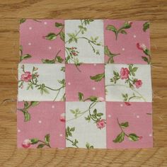 a pink and white patchwork with flowers on it