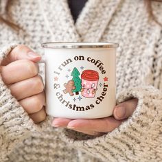 a woman is holding a coffee mug with christmas cheer written on the front and bottom