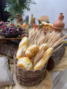 bread in a basket on a table with other food items