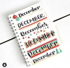 a spiral notebook with the words december and december written on it