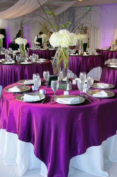 a purple table cloth with white flowers and place settings on it for an ebay event