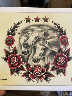 a drawing of two horses surrounded by roses and starbursts on white paper