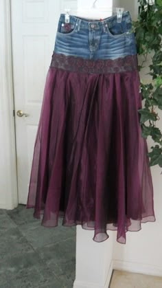 a purple skirt is hanging on a door