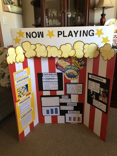 a display board with popcorn on it in the middle of a carpeted flooring area