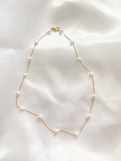 A dainty heart pearl on gold chain necklace. Simple for everyday wear. Ensure to measure neck with measuring tape in inches. (You may want to leave a little extra room so your necklace is not too tight) Please select your length you would like you choker to be at checkout. Gold plated Gold Heart Shaped Pearl Chain Necklace, Dainty Heart Necklace With Pearl Chain, Dainty Gold Pearl Necklace With Heart Pendant, Dainty White Chain Necklace With Pearl Charm, Dainty Gold Heart-shaped Pearl Necklace, White Pearl Heart Necklace With Clavicle Chain, Dainty Pearl White Chain Necklace With Adjustable Chain, Delicate Gold Heart Pendant Pearl Necklace, Dainty Gold Pearl Necklace With Heart Beads