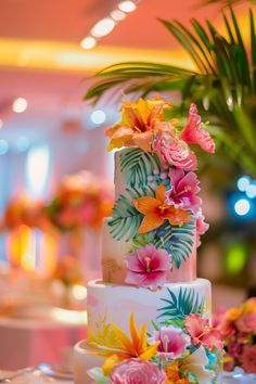 a wedding cake decorated with flowers and leaves