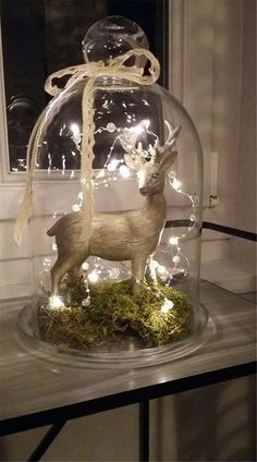 a glass clochet with a deer in it