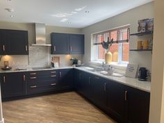 a kitchen with black cabinets and white counter tops