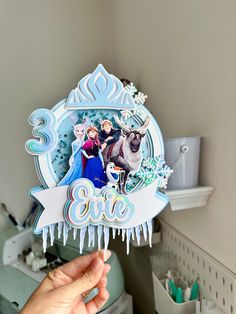 someone is holding up a frozen birthday card