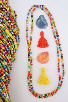 You can create your own boho style in a flash with these festive and bright "LOVE beads."Made in former Czechoslovakia for use in Africa, these beads have been in our possession for 20+ years, stored in a warehouse. The colors in these strands will go with just about anything and are super-fun for layering on as summer necklaces! No two strands are alike.Bead Size: Approx. 4x3mm, but that does vary as there are lots of different bead shapes on these strands.Strand Length: Approx. 36"Approximate Festive Bohemian Beaded Necklaces With Tiny Beads, Festive Bohemian Beaded Necklace With Tiny Beads, Large Multicolor Beads For Beach, Multicolor Wooden Beads For Festival, Multicolor Large Beads For Crafting, Large Multicolor Beads For Crafting, Bohemian Beaded Bracelets With Oval Beads For Beach, Artisan Multicolor Beaded Necklace For Beach, Beach Beaded Necklace With Large Oval Beads