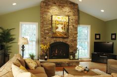 a living room filled with furniture and a fire place in front of a painting on the wall