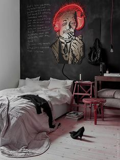 a bedroom with a chalkboard on the wall and headphones hanging from the ceiling