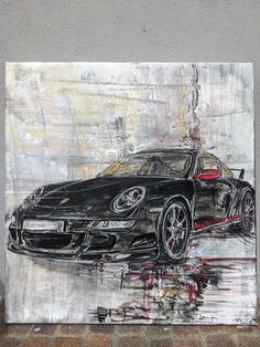 a painting of a black sports car is on display in a room with tile flooring