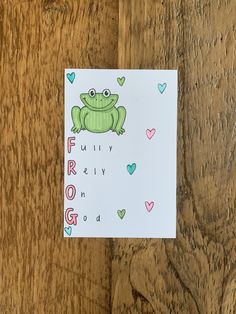 a frog is sitting on top of a piece of paper