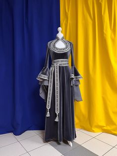 The dress is made from artificial velvet in gray color. Sleeves and a belt are decorated with the wide silver knitted and woven braid. The main decoration of a dress is sleeves which beautifully fall down and have the real elfin appearance. There aren't any fasteners on the dress, thanks to ability of fabric it is good to stretch. The suit consists of a dress and a belt. Material: velvet. The dress can be made in any size. Production of a dress takes 7-10 working days. Fitted Long Sleeve Elven Medieval Dress, Elvish Fitted Long Sleeve Medieval Dress, Fitted Elven Medieval Dress Floor-length, Elven Style Fitted Medieval Floor-length Dress, Velvet Medieval Dress, Elf Dress, Elven Dress, Medieval Dress, Women's Costumes