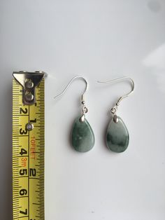 A pair of real green&white jade teardrop earrings with 925 Sterling Silver hook. The simple and delicate teardrop earrins are carved from Grade-A quality green icy jade. The jade color is all-natural and genuine, clear jade texture can be easily observed under the daylight. Some highlights of this pair of minimalistic jade earrings: *High quality guaranteed. Grade-A natural green jade, handmade with 925 sterling silver. *Graceful and simple teardrop design *Each teardrop is measured around 1 Green Drop Earrings, Pierced, Green Pierced Drop Earrings, Green Drop Jewelry For Jewelry Making, Teardrop Jade Gemstone Earrings, Nickel-free Green Drop Jewelry, Green Nickel-free Drop Jewelry, Green Pear-shaped Teardrop Earrings, Green Teardrop Drop Earrings Nickel Free, Green Nickel-free Teardrop Drop Earrings