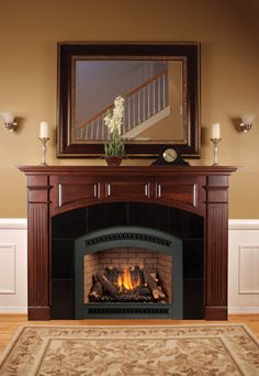 a fire place with a mirror above it