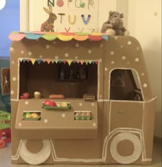 a very cute looking food cart made out of cardboard