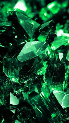 many green crystals are shown in this close up photo, with the light shining on them