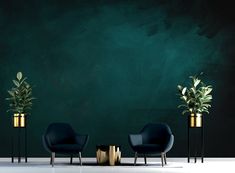 three black chairs and two gold vases in front of a green wall with plants