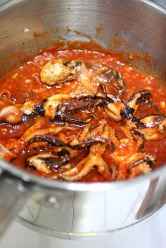 the food is being cooked in the pot on the stove top and ready to be eaten