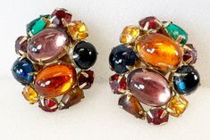 "Earrings, WEISS, Eisenberg, Juliana, Warner Multi Color Glass Cabochon Rhinestones Jewels Of India Clip Earrings High Quality Women's Estate Jewelry Costume Fashion RARE! Vintage Weiss Multicolor Cabochon Stone Clip On Earrings Condition - Very Good Vintage Condition Size - 1.25\" x 1\" Weight - 19.2g Marked - Weiss Both are in very good condition with no damage or missing stones, and the clips work great.      These are an estate sale find and my home is smoke-free. Condition - Very Good Vintage Condition All jewelry items will arrive in a lovely gift box with ribbon...Ready for gift giving. FAST 1 Day Shipping From A Non-Smoking Environment. PRIORITY SHIPPING IS AVAILABLE! I ship worldwide and I do combine shipping, so send me a message and I will adjust shipping for you. Find more beau Multicolor Cabochon Costume Jewelry, Vintage Cabochon Clip-on Earrings For Formal Occasions, Glass Cabochon Jewelry, Luxury Vintage Cabochon Earrings, Vintage Clip-on Cabochon Earrings As Gift, Retro Gold Clip-on Cabochon Earrings, Costume Fashion, Clip Earrings, Multi Stone