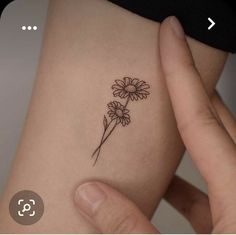 a woman's arm with a flower tattoo on the left side of her body