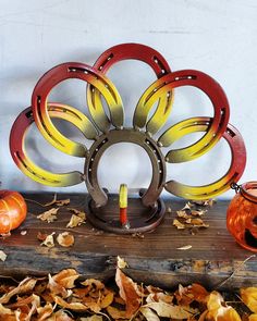 a wooden table topped with lots of pumpkins and other decorations on top of it