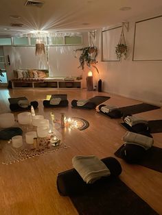 an empty room with candles and yoga mats on the floor