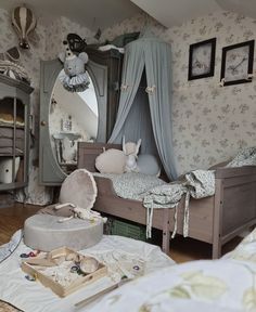 a bedroom with a bed, mirror and toys on the floor in front of it