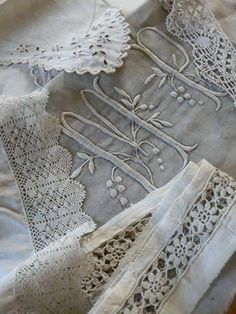 several pieces of white linen with lace on them