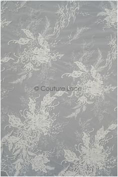 white flowers and leaves on grey background with the word couture lace written below