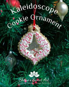 a close up of a christmas ornament on a tree with the words kaleidoscope cookie ornaments