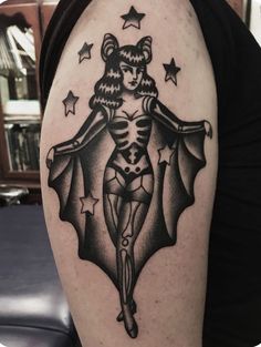 a woman with a bat tattoo on her arm is shown in black and grey colors