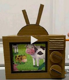 a cardboard box with an image of a cow on it and some other items in front of it