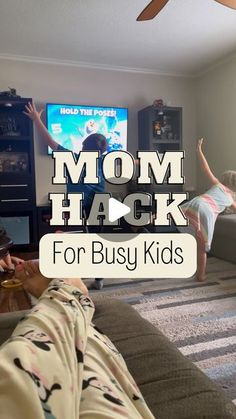 two children are playing video games in the living room with text overlay that reads mom hack for busy kids