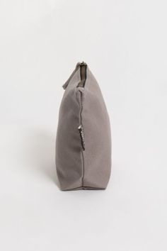 If you’ve been looking for an eco-friendly makeup bag to tame and organize cosmetic items, consider the simple and affordable Lok Pouch. Made from sustainably grown organic cotton canvas, the Lok Pouch’s dimensions (7" X 9" x 3" ) are large enough to accommodate most cosmetic containers and accessories but small enough to easily toss into a larger tote or pack. It has a 7-inch zippered opening with a long pull and a gusseted bottom panel, so it stands up on the countertop for easy access. Conten Eco Friendly Makeup, Cosmetic Items, Cosmetic Containers, Zippered Pouch, Large Tote, Zipper Pouch, Easy Access, Makeup Bag, Cotton Canvas