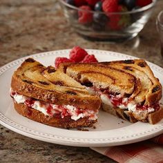 a grilled cheese sandwich on a plate with raspberries