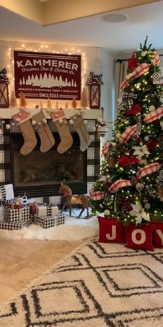 a decorated christmas tree with stockings hanging from it's sides in front of a fireplace