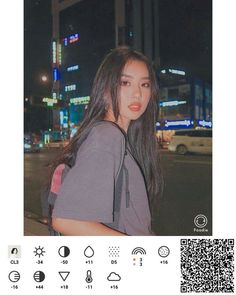 a girl with long hair standing in front of a city street at night, wearing a backpack