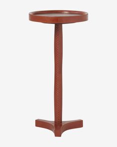 a small wooden table with a circular top and pedestal on one end, in the shape of a column