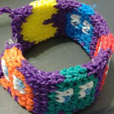 a close up of a bracelet made out of crocheted yarn and plastic beads