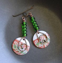 A different twist to your usual holiday earrings featuring green and reddish coral enamel charms. The abstract pattern on the enamels reminds me of a tree branch. I have paired them with spiraling green lampwork beads and copper beads. I have accented them with teardrop shaped copper components. These unique earrings measure 2 1/2 inches in total length and hang on niobium earring hooks. All pieces come boxed ready for gift giving or keeping for yourself. Return to shop: bstrung.etsy.com More li Bohemian Green Jewelry For Holiday, Festive Green Earrings With Colorful Beads, Green Earrings With Colorful Beads For Gifts, Green Wire Wrapped Beaded Earrings For Gift, Green Wire Wrapped Beaded Earrings As Gift, Festive Green Nickel-free Earrings, Green Spiral Earrings As Gift, Blue And White Earrings, Lampwork Bead Earrings