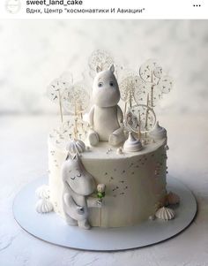 a white cake decorated with an image of two animals